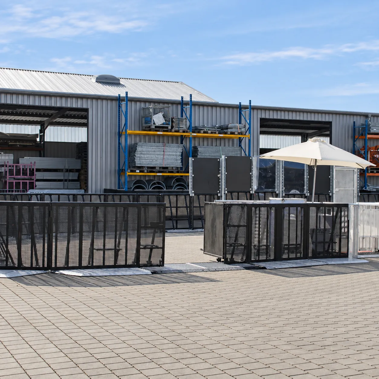 Black Mojo Barrier Alternative Doors in a barrier line outside a warehouse