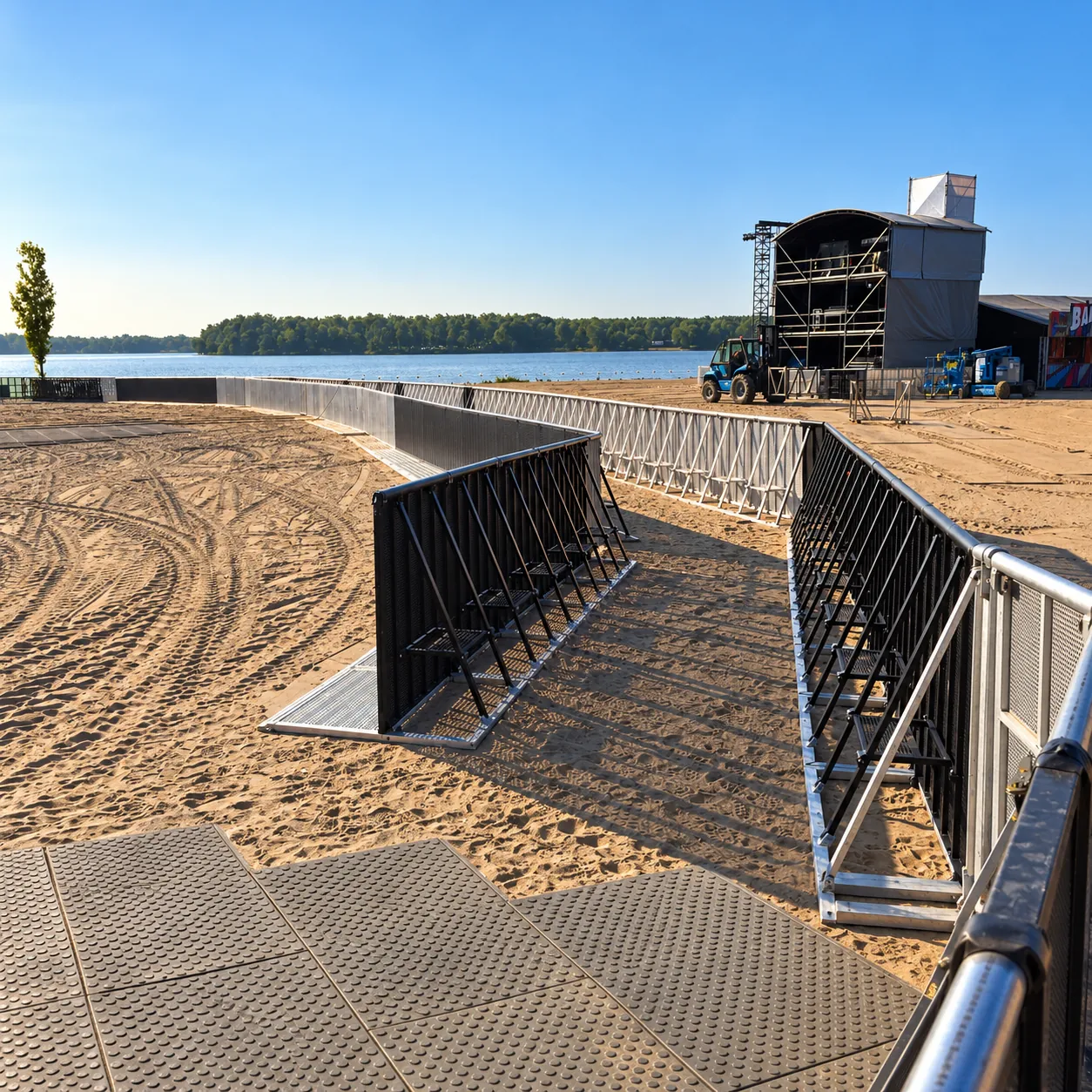 Black and aluminium Mojo Barrier lines on a beach by a lake