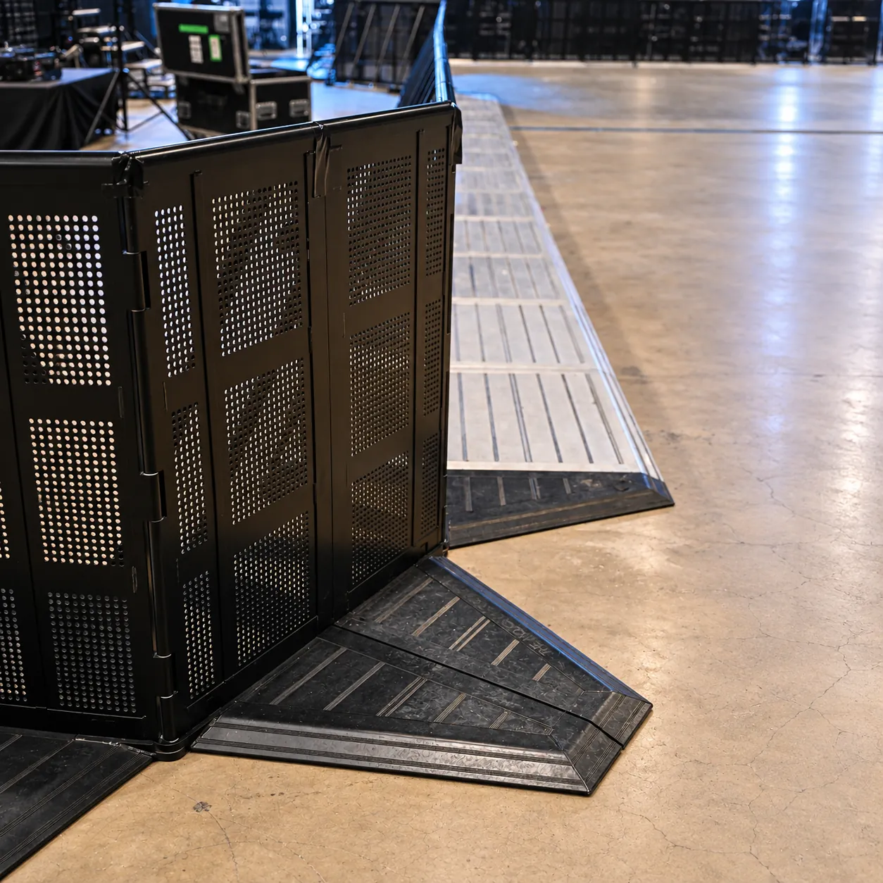Corner of a black Mojo Barrier line with base plates, detail