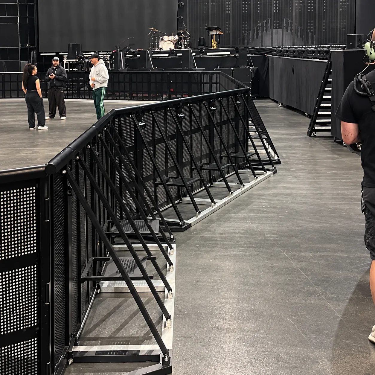 Black Mojo Barrier line with a hinged corner on an indoor arena floor