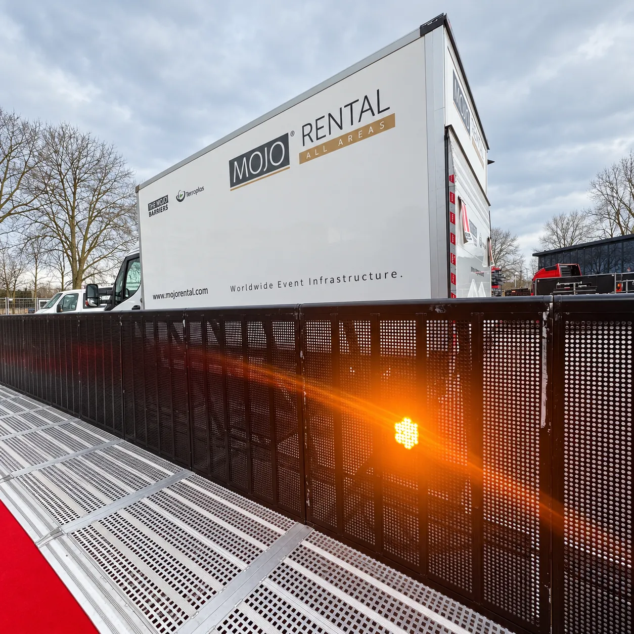 Black Mojo Barrier line in front of a MOJO Rental truck