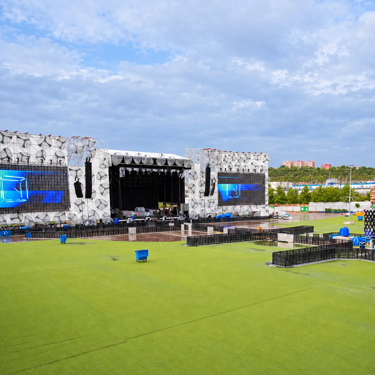 Black Mojo Barrier lines on a stadium pitch in front of a large stage
