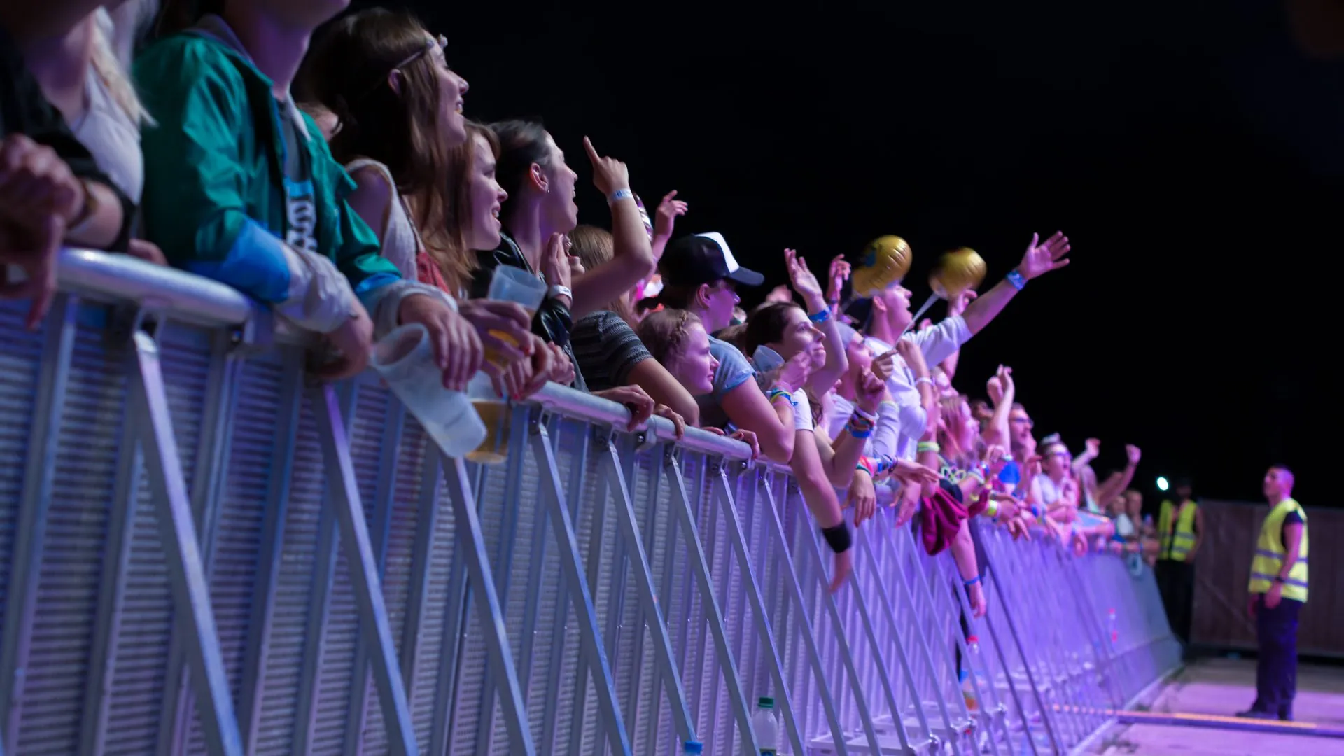 Fans at the Mojo front-of-stage barrier at night