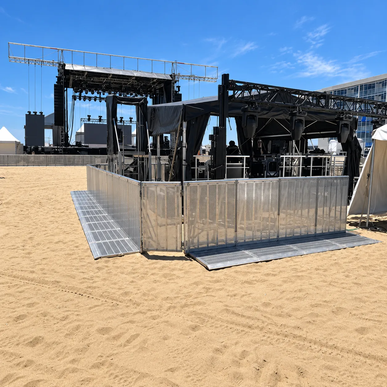 Mojo Barrier enclosure on sand at a beach festival