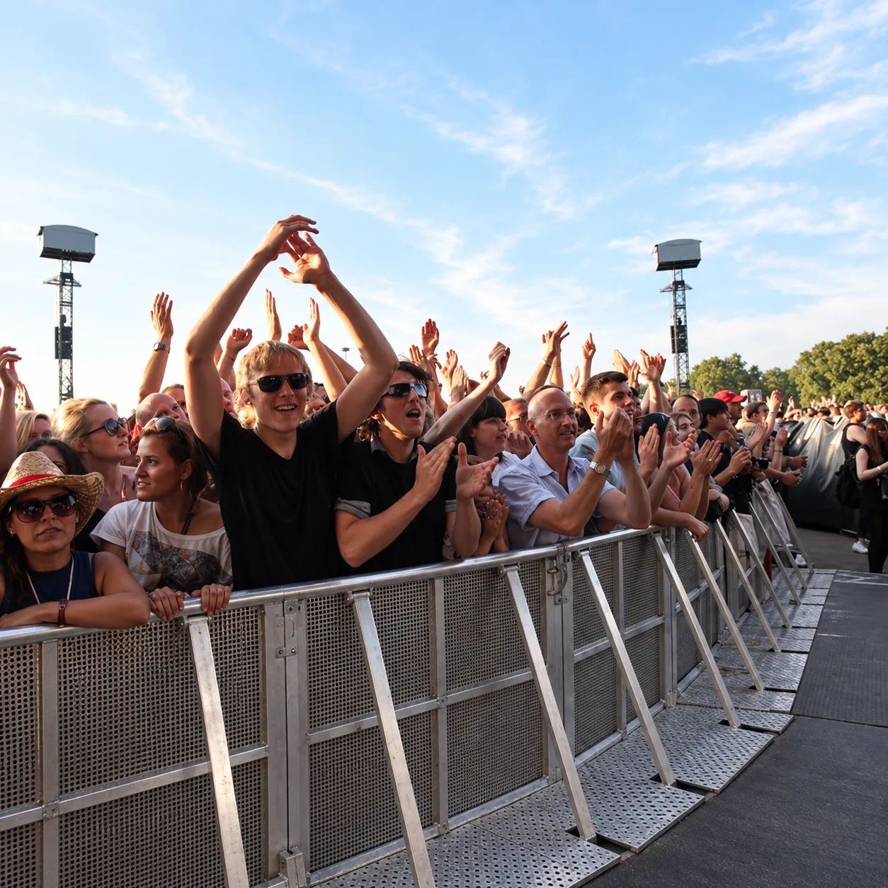 Crowd at the Mojo front-of-stage barrier at an open-air concert