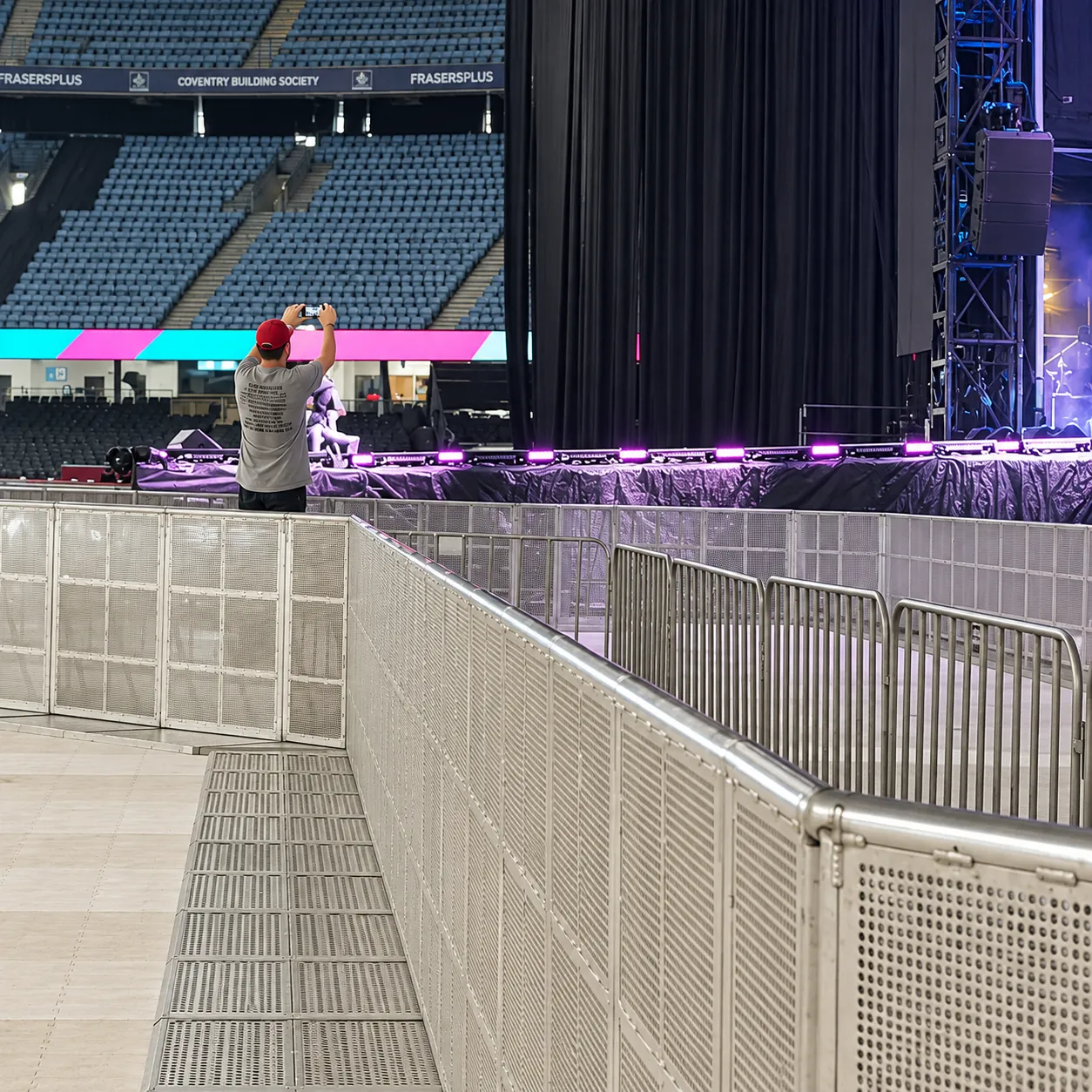 Mojo Barrier photo pit in front of a stadium stage
