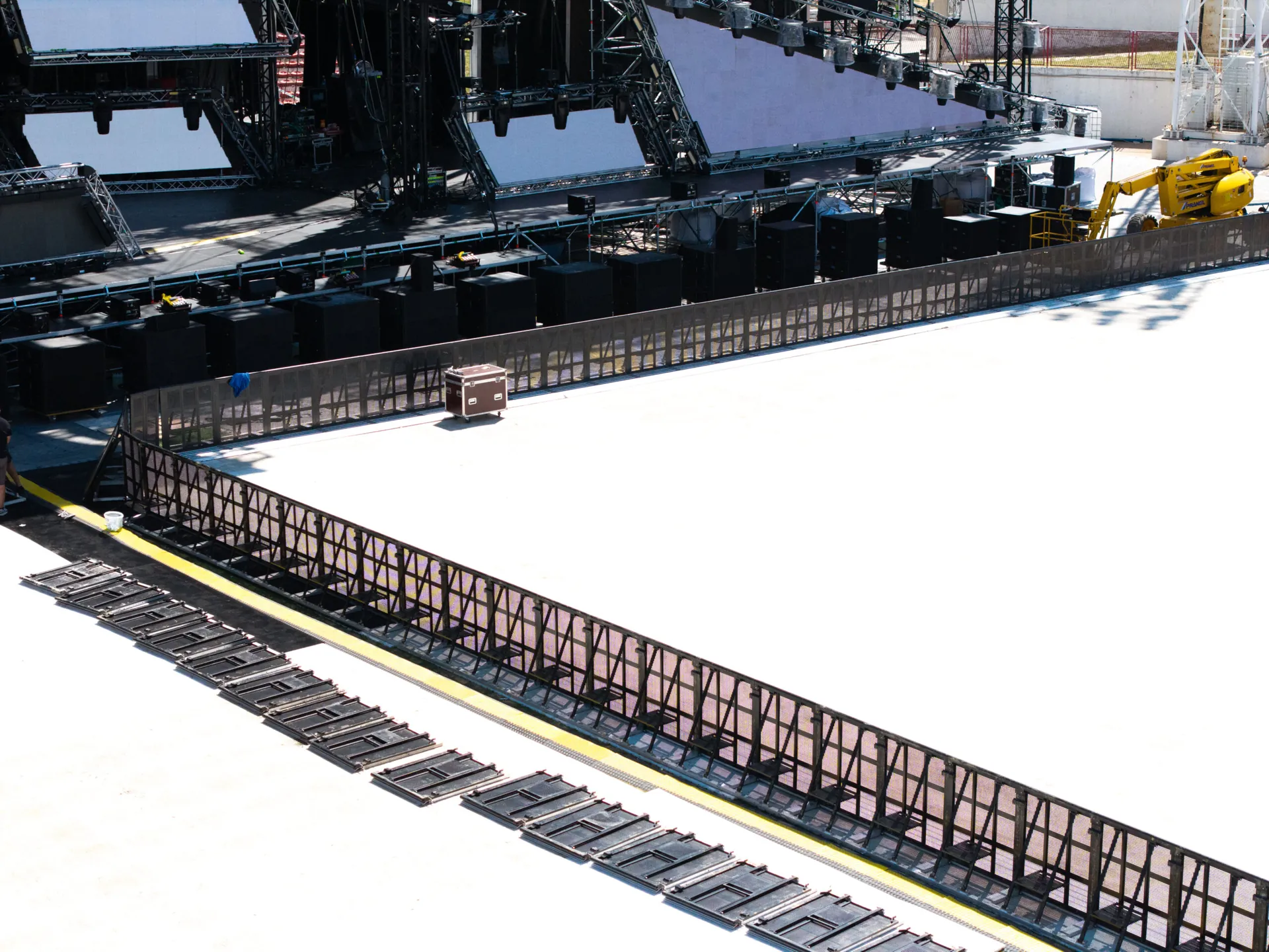 Aerial view of black Mojo front-of-stage barriers in a stadium