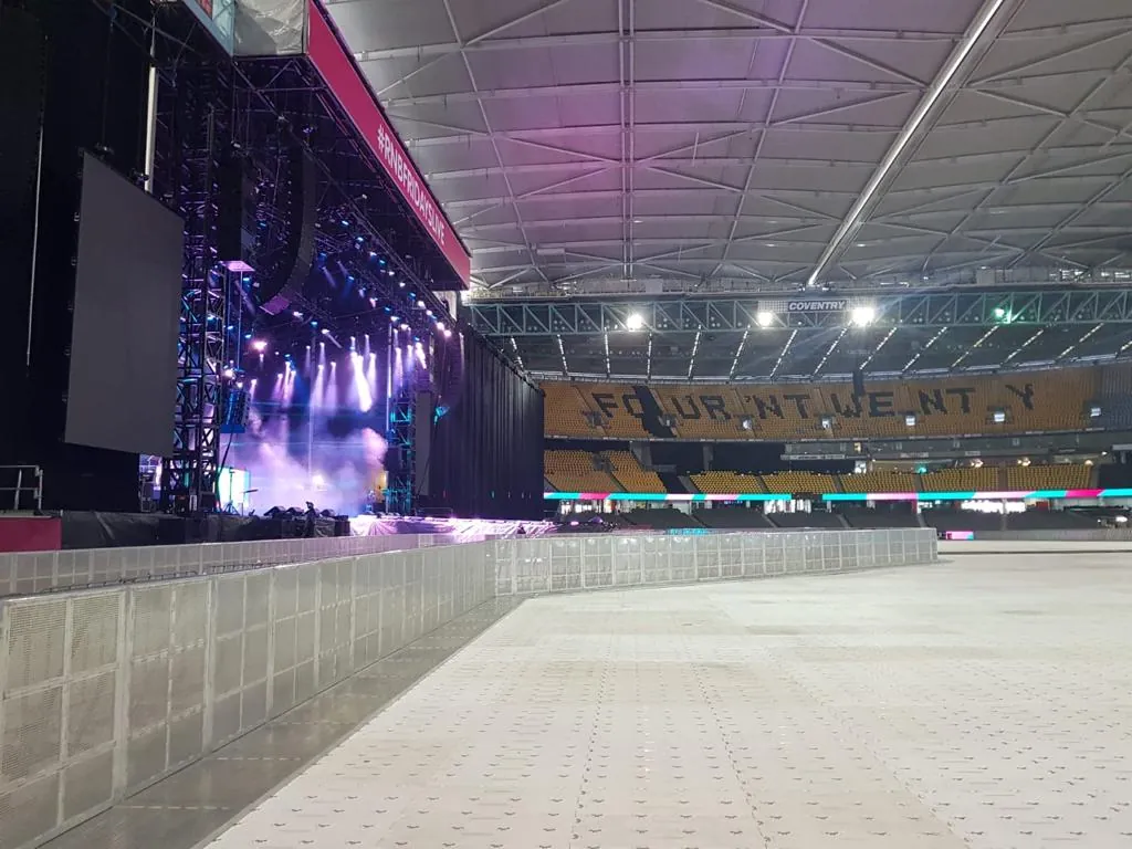 Mojo Barriers front of stage in a covered stadium