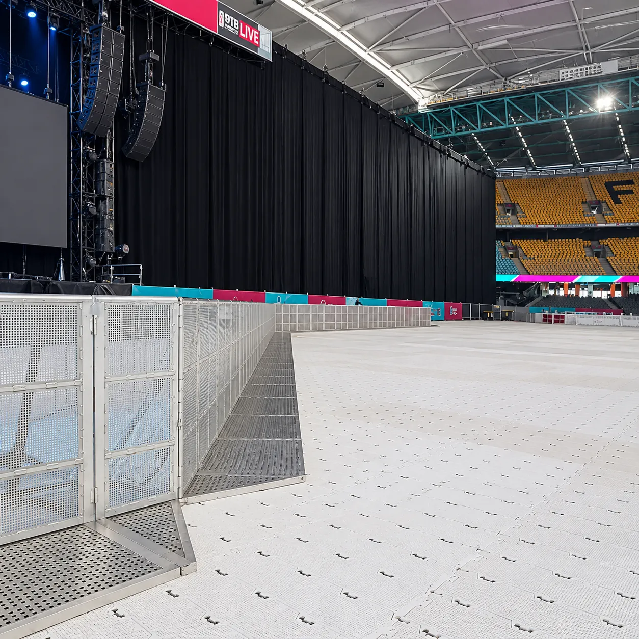 Mojo Barrier Straight Sections on a stadium floor