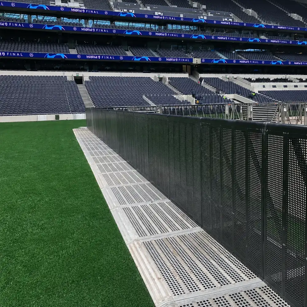 Black Mojo Barrier line with silver floor plates on a stadium pitch