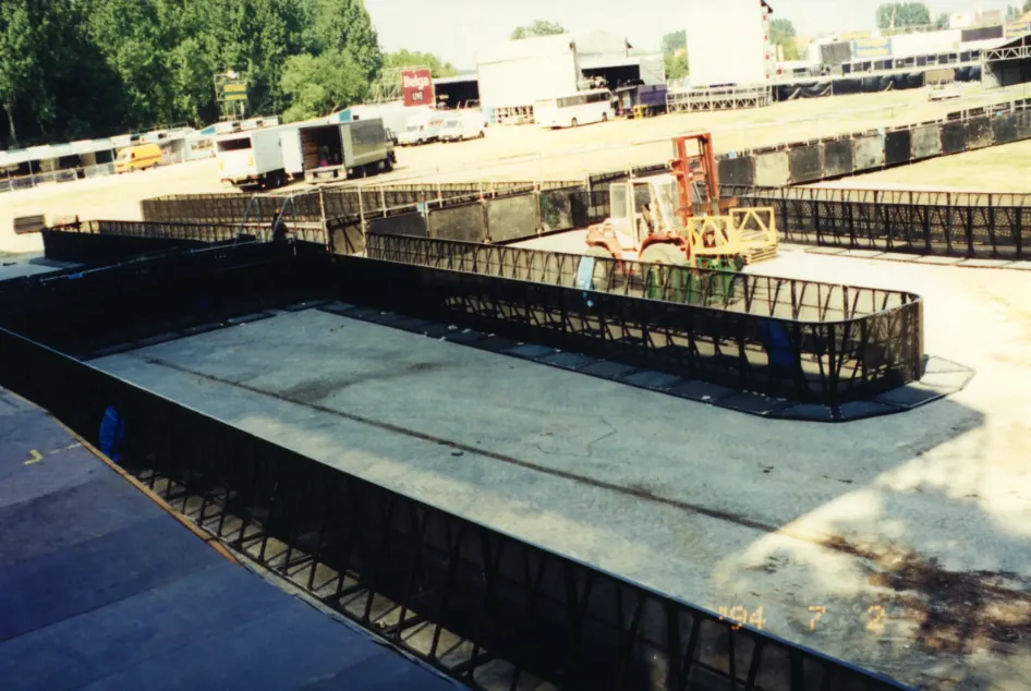 Black steel Mojo Barrier line of the first generation in front of a stage during build-up, 1994