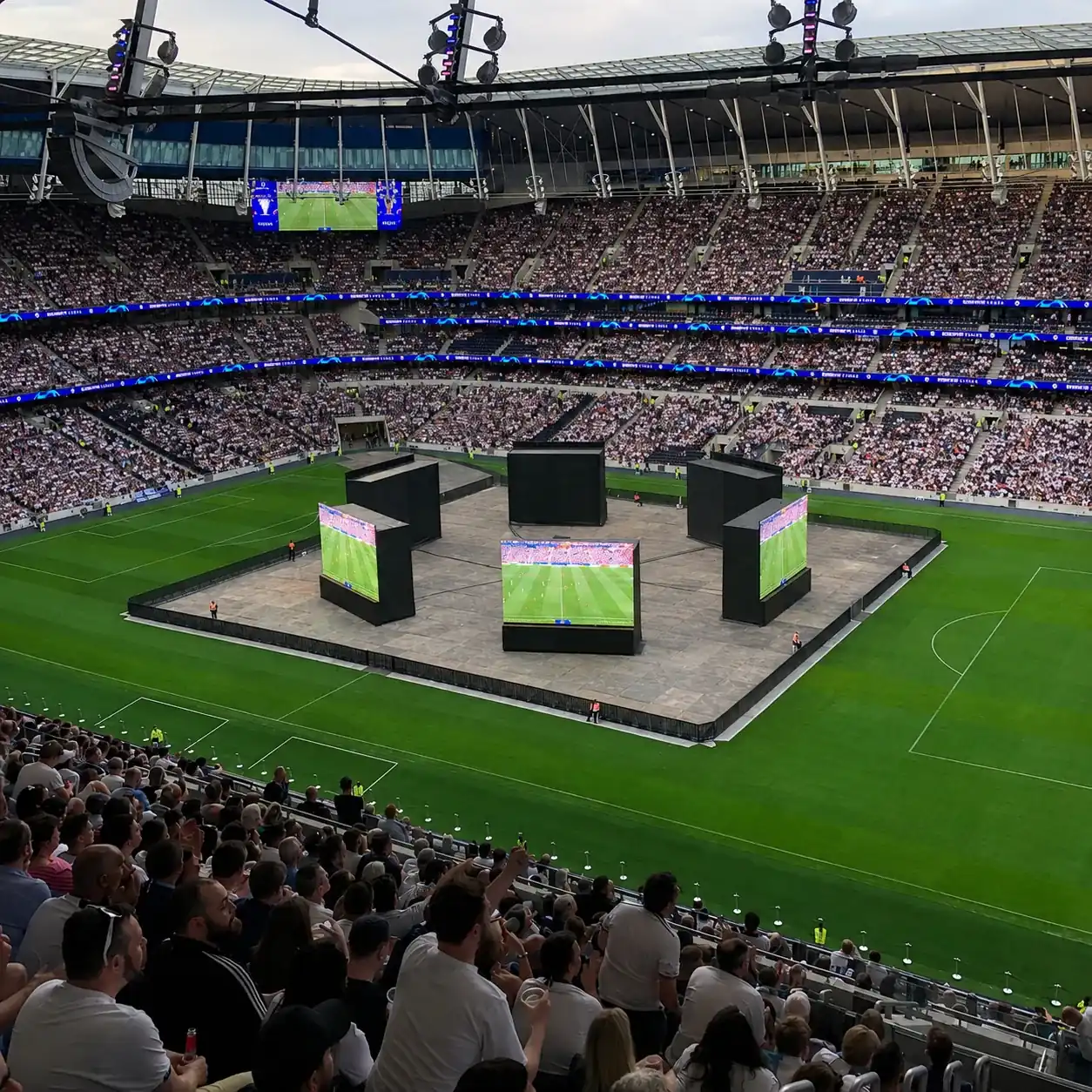 Black Mojo Barriers around a stage area on the pitch of a full stadium